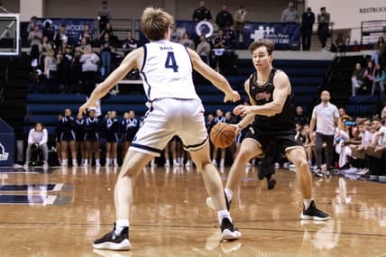 Jan 19, 2023; West Long Branch, New Jersey, USA; Charleston Cougars guard Reyne Smith (2) sets the play as Monmouth Hawks guard Andrew Ball (4) defends during the first half at OceanFirst Bank Center. Mandatory Credit: John Jones-USA TODAY Sports