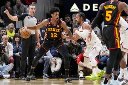Jan 20, 2023; Atlanta, Georgia, USA; Atlanta Hawks forward De'Andre Hunter (12) dribbles against New York Knicks guard Jalen Brunson (11) during the first half at State Farm Arena. Mandatory Credit: Dale Zanine-USA TODAY Sports