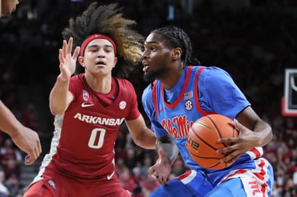 Jan 21, 2023; Fayetteville, Arkansas, USA; Ole Miss Rebels guard Amaree Abram (1) drives against Arkansas Razorbacks guard Anthony Black (0) during the first half at Bud Walton Arena. Mandatory Credit: Nelson Chenault-USA TODAY Sports
