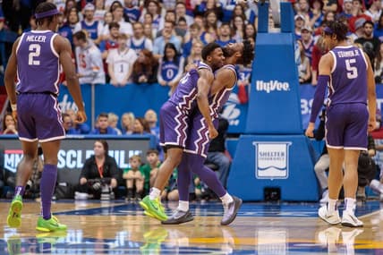 Jan 21, 2023; Lawrence, Kansas, USA; TCU Horned Frogs guard Mike Miles Jr. (1) hugs TCU Horned Frogs guard Shahada Wells (13) in reaction to a play during the second half against the Kansas Jayhawks at Allen Fieldhouse. Mandatory Credit: William Purnell-USA TODAY Sports