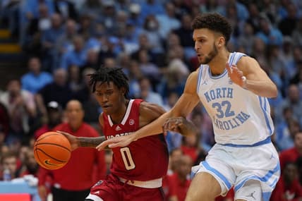 Jan 21, 2023; Chapel Hill, North Carolina, USA;  North Carolina State Wolfpack guard Terquavion Smith (0) dribbles as North Carolina Tar Heels forward Pete Nance (32) defends in the first half at Dean E. Smith Center. Mandatory Credit: Bob Donnan-USA TODAY Sports