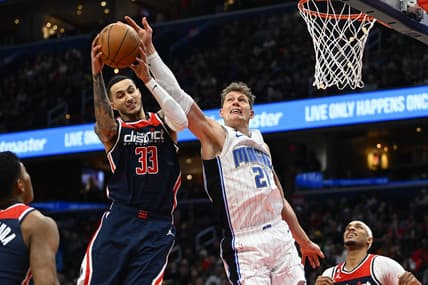 Jan 21, 2023; Washington, District of Columbia, USA; Washington Wizards forward Kyle Kuzma (33) grabs a rebound over Orlando Magic center Moritz Wagner (21) during the first half at Capital One Arena. Mandatory Credit: Brad Mills-USA TODAY Sports