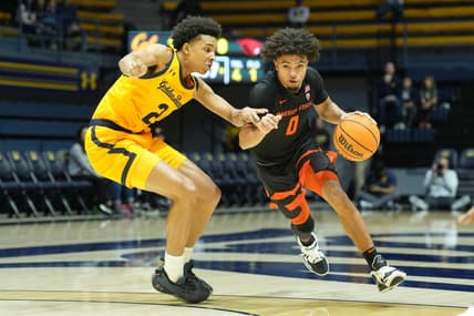 Jan 22, 2023; Berkeley, California, USA; Oregon State Beavers guard Jordan Pope (0) dribbles against California Golden Bears forward Monty Bowser (2) during the first half at Haas Pavilion. Mandatory Credit: Darren Yamashita-USA TODAY Sports