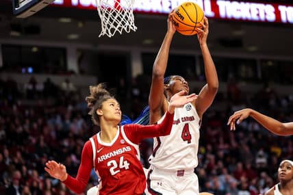 Jan 22, 2023; Columbia, South Carolina, USA; South Carolina Gamecocks forward Aliyah Boston (4) grabs a rebound over Arkansas Razorbacks guard Jersey Wolfenbarger (24) in the first half at Colonial Life Arena. Mandatory Credit: Jeff Blake-USA TODAY Sports