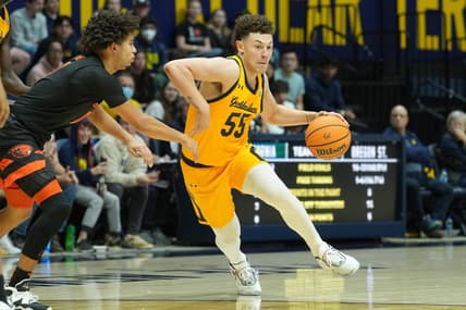 Jan 22, 2023; Berkeley, California, USA; California Golden Bears guard Devin Askew (55) dribbles against Oregon State Beavers guard Jordan Pope (0) during the second half at Haas Pavilion. Mandatory Credit: Darren Yamashita-USA TODAY Sports