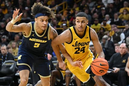 Jan 12, 2023; Iowa City, Iowa, USA; Iowa Hawkeyes forward Kris Murray (24) and Michigan Wolverines forward Terrance Williams II (5) in action during the game at Carver-Hawkeye Arena. Mandatory Credit: Jeffrey Becker-USA TODAY Sports