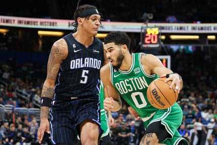 Jan 23, 2023; Orlando, Florida, USA;  Boston Celtics forward Jayson Tatum (0) drives ti the basket past Orlando Magic forward Paolo Banchero (5) in the first quarter at Amway Center. Mandatory Credit: Nathan Ray Seebeck-USA TODAY Sports