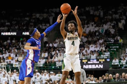 Jan 23, 2023; Waco, Texas, USA; Baylor Bears guard LJ Cryer (4) scores a three-point basket against Kansas Jayhawks guard Dajuan Harris Jr. (3) during the first half at Ferrell Center. Mandatory Credit: Chris Jones-USA TODAY Sports