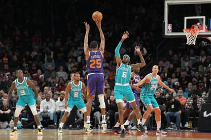 Jan 24, 2023; Phoenix, Arizona, USA; Phoenix Suns forward Mikal Bridges (25) shoots over Charlotte Hornets forward Jalen McDaniels (6) during the first half at Footprint Center. Mandatory Credit: Joe Camporeale-USA TODAY Sports