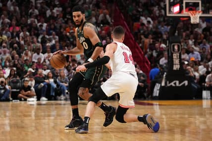 Jan 24, 2023; Miami, Florida, USA; Boston Celtics forward Jayson Tatum (0) dribbles the ball around Miami Heat guard Tyler Herro (14) during the second half at Miami-Dade Arena. Mandatory Credit: Jasen Vinlove-USA TODAY Sports
