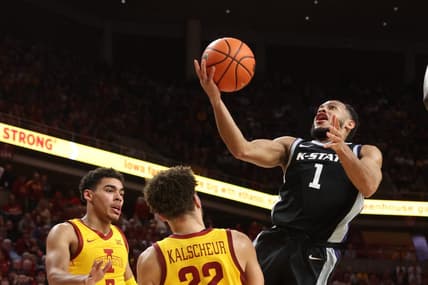 Jan 24, 2023; Ames, Iowa, USA; Kansas State Wildcats guard Markquis Nowell (1) shoots over Iowa State Cyclones guard Tamin Lipsey (3) and Iowa State Cyclones guard Gabe Kalscheur (22) during the first half at James H. Hilton Coliseum. Mandatory Credit: Reese Strickland-USA TODAY Sports