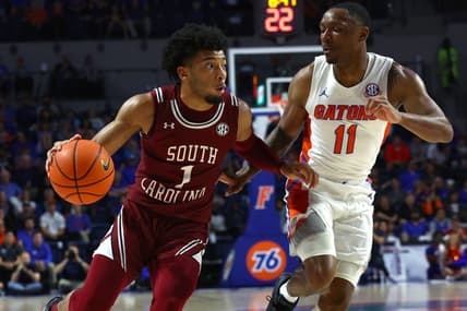 Jan 25, 2023; Gainesville, Florida, USA; South Carolina Gamecocks guard Jacobi Wright (1) drives to the basket as Florida Gators guard Kyle Lofton (11) defends during the first half at Exactech Arena at the Stephen C. O'Connell Center. Mandatory Credit: Kim Klement-USA TODAY Sports
