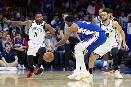 Jan 25, 2023; Philadelphia, Pennsylvania, USA; Philadelphia 76ers center Joel Embiid (21) controls a loose ball over Brooklyn Nets guard Kyrie Irving (11) and guard Ben Simmons (10) during the second quarter at Wells Fargo Center. Mandatory Credit: Bill Streicher-USA TODAY Sports