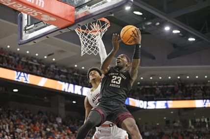 Jan 25, 2023; Auburn, Alabama, USA; Texas A&M Aggies guard Tyrece Radford (23) gets past Auburn Tigers center Dylan Cardwell (44) for a shot during the first half at Neville Arena. Mandatory Credit: John Reed-USA TODAY Sports