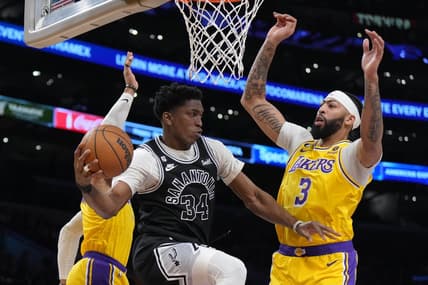 Jan 25, 2023; Los Angeles, California, USA; San Antonio Spurs forward Stanley Johnson (34) passes the ball against Los Angeles Lakers forward Anthony Davis (3) and guard Russell Westbrook (0) in the first half at Crypto.com Arena. Mandatory Credit: Kirby Lee-USA TODAY Sports