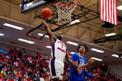 Jan 26, 2023; Boca Raton, Florida, USA; Florida Atlantic Owls guard Johnell Davis (1) shoots over Middle Tennessee Blue Raiders guard Teafale Lenard Jr. (12) during the first half at Eleanor R. Baldwin Arena. Mandatory Credit: Rich Storry-USA TODAY Sports