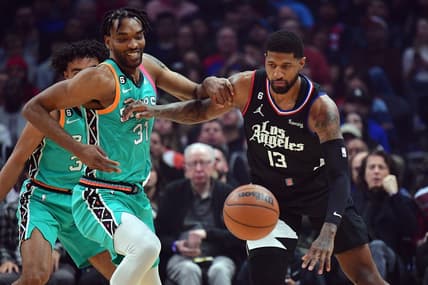Jan 26, 2023; Los Angeles, California, USA; San Antonio Spurs forward Keita Bates-Diop (31) plays for the ball against Los Angeles Clippers guard Paul George (13) during the first half at Crypto.com Arena. Mandatory Credit: Gary A. Vasquez-USA TODAY Sports
