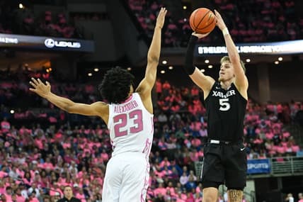 Jan 28, 2023; Omaha, Nebraska, USA;  Xavier Musketeers guard Adam Kunkel (5) scores over Creighton Bluejays guard Trey Alexander (23) in the first half at CHI Health Center Omaha. Mandatory Credit: Steven Branscombe-USA TODAY Sports
