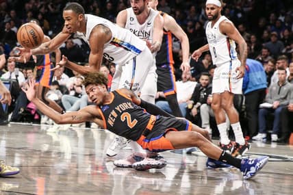 Jan 28, 2023; Brooklyn, New York, USA;  Brooklyn Nets center Nic Claxton (33) and New York Knicks guard Miles McBride (2) fight for a loose ball in the second quarter at Barclays Center. Mandatory Credit: Wendell Cruz-USA TODAY Sports