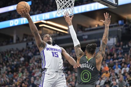 Jan 28, 2023; Minneapolis, Minnesota, USA; Sacramento Kings guard Davion Mitchell (15) goes to the basket as Minnesota Timberwolves guard D'Angelo Russell (0) defends during the second quarter at Target Center. Mandatory Credit: Jeffrey Becker-USA TODAY Sports
