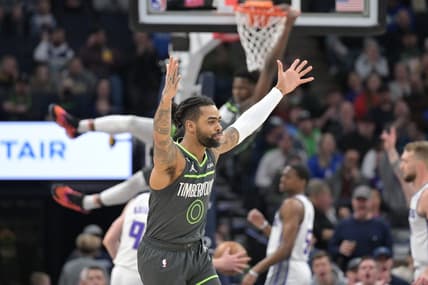 Jan 28, 2023; Minneapolis, Minnesota, USA; Minnesota Timberwolves guard D'Angelo Russell (0) reacts as guard Anthony Edwards (1) hangs from the rim against the Sacramento Kings during the first quarter at Target Center. Mandatory Credit: Jeffrey Becker-USA TODAY Sports