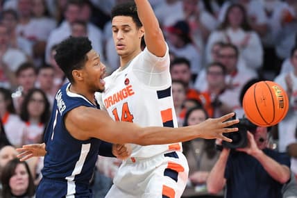 Jan 30, 2023; Syracuse, New York, USA; Virginia Cavaliers forward Jayden Gardner (1) passes the ball around Syracuse Orange center Jesse Edwards (14) during the first half at the JMA Wireless Dome. Mandatory Credit: Rich Barnes-USA TODAY Sports