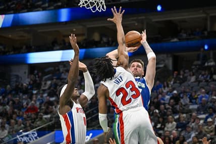 Jan 30, 2023; Dallas, Texas, USA; Dallas Mavericks guard Luka Doncic (77) looks to passes the ball over Detroit Pistons guard Jaden Ivey (23) and center Jalen Duren (0) during the first quarter at the American Airlines Center. Mandatory Credit: Jerome Miron-USA TODAY Sports