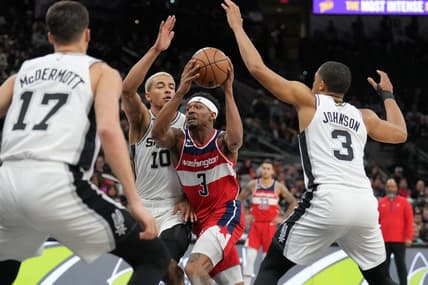 Jan 30, 2023; San Antonio, Texas, USA;  Washington Wizards guard Bradley Beal (3) drives between San Antonio Spurs forwards Jeremy Sochan (10) and Keldon Johnson (3) in the first half at the AT&T Center. Mandatory Credit: Daniel Dunn-USA TODAY Sports