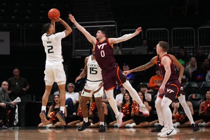 Jan 31, 2023; Coral Gables, Florida, USA; Miami Hurricanes guard Isaiah Wong (2) attempts a three point shot over Virginia Tech Hokies guard Hunter Cattoor (0) during the first half at Watsco Center. Mandatory Credit: Jasen Vinlove-USA TODAY Sports