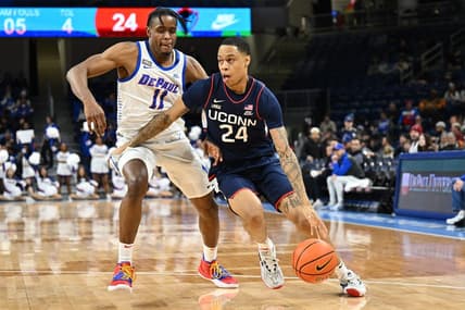 Jan 31, 2023; Chicago, Illinois, USA; Connecticut Huskies guard Jordan Hawkins (24) drives to the basket around DePaul Blue Demons forward Eral Penn (11) in the first half at Wintrust Arena. Mandatory Credit: Jamie Sabau-USA TODAY Sports