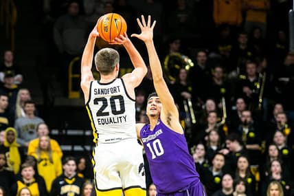 Iowa forward Payton Sandfort (20) makes a 3-point basket as Northwestern forward Tydus Verhoeven (10) defends during a NCAA Big Ten Conference men's basketball game, Tuesday, Jan. 31, 2023, at Carver-Hawkeye Arena in Iowa City, Iowa.

230131 N Western Iowa Mbb 034 Jpg