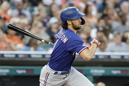 Jun 17, 2022; Detroit, Michigan, USA; Texas Rangers third baseman Charlie Culberson (11) hits an RBI single in the sixth inning against the Detroit Tigers at Comerica Park. Mandatory Credit: Rick Osentoski-USA TODAY Sports