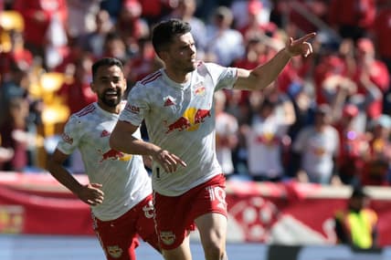 Oct 15, 2022; Harrison, New Jersey, USA; New York Red Bulls midfielder Lewis Morgan (10) celebrates with midfielder Luquinhas (82) after scoring a goal against FC Cincinnati during the second half at Red Bull Arena. Mandatory Credit: Vincent Carchietta-USA TODAY Sports