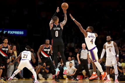 Oct 23, 2022; Los Angeles, California, USA;  Portland Trail Blazers guard Damian Lillard (0) shoots a three-pointer against Los Angeles Lakers guard Lonnie Walker IV (4) during the fourth quarter at Crypto.com Arena. Mandatory Credit: Kiyoshi Mio-USA TODAY Sports