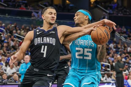 Nov 14, 2022; Orlando, Florida, USA; Orlando Magic guard Jalen Suggs (4) defends Charlotte Hornets forward P.J. Washington (25) during the second quarter at Amway Center. Mandatory Credit: Mike Watters-USA TODAY Sports