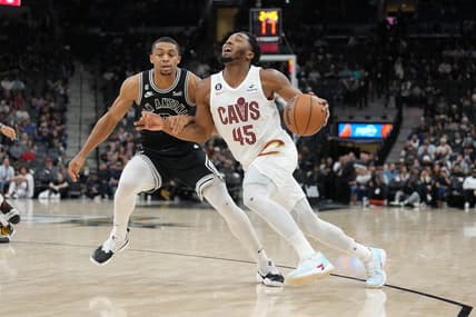 Dec 12, 2022; San Antonio, Texas, USA; Cleveland Cavaliers guard Donovan Mitchell (45) dribbles past San Antonio Spurs forward Keldon Johnson (3) in the second half at the AT&T Center. Mandatory Credit: Daniel Dunn-USA TODAY Sports