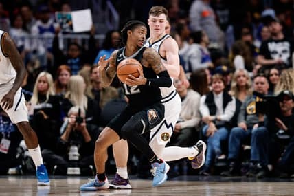 Dec 20, 2022; Denver, Colorado, USA; Memphis Grizzlies guard Ja Morant (12) controls the ball as Denver Nuggets guard Christian Braun (0) guards in the third quarter at Ball Arena. Mandatory Credit: Isaiah J. Downing-USA TODAY Sports