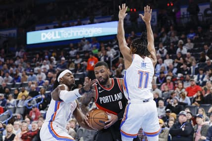 Dec 21, 2022; Oklahoma City, Oklahoma, USA;  Portland Trail Blazers guard Damian Lillard (0) is defended by Oklahoma City Thunder guard Luguentz Dort (5) and guard Isaiah Joe (11) during the second quarter at Paycom Center. Mandatory Credit: Alonzo Adams-USA TODAY Sports