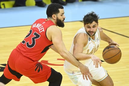 Dec 23, 2022; Cleveland, Ohio, USA; Cleveland Cavaliers guard Raul Neto (19) dribbles beside Toronto Raptors guard Fred VanVleet (23) in the third quarter at Rocket Mortgage FieldHouse. Mandatory Credit: David Richard-USA TODAY Sports
