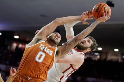 Texas Longhorns forward Timmy Allen (0) and Oklahoma Sooners forward Tanner Groves (35) reach for the ball during an NCAA men's college basketball game between the University of Oklahoma and Texas at Lloyd Noble Center in Norman, Okla., Saturday, Dec. 31, 2022. Texas won 70-69.

Oklahoma Vs Texas Basketball