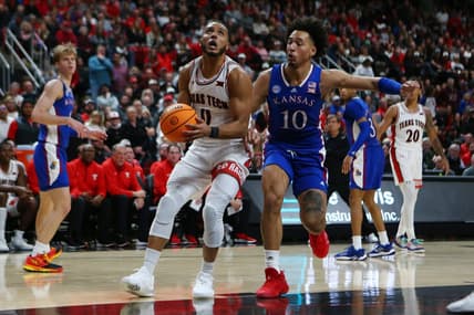 Jan 3, 2023; Lubbock, Texas, USA;  Texas Tech Red Raiders forward Kevin Obanor (0) stops to shoot against Kansas Jayhawks forward Jalen Wilson (10) in the second half at United Supermarkets Arena. Mandatory Credit: Michael C. Johnson-USA TODAY Sports