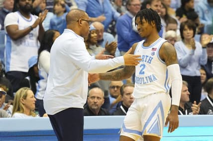 Jan 7, 2023; Chapel Hill, North Carolina, USA;  North Carolina Tar Heels coach Hubert Davis greets guard Caleb Love (2) after he come out of the game against the Notre Dame Fighting Irish during the second half at Dean E. Smith Center. Mandatory Credit: James Guillory-USA TODAY Sports