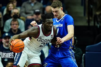 Jan 7, 2023; Storrs, Connecticut, USA; UConn Huskies forward Adama Sanogo (21) moves the ball against Creighton Bluejays center Ryan Kalkbrenner (11) in the second half at Harry A. Gampel Pavilion. Mandatory Credit: David Butler II-USA TODAY Sports