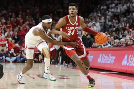 Jan 11, 2023; Fayetteville, Arkansas, USA; Alabama Crimson Tide forward Brandon Miller (24) dribbles by Arkansas Razorbacks guard Davonte Davis (4) during the first half at Bud Walton Arena. Mandatory Credit: Nelson Chenault-USA TODAY Sports