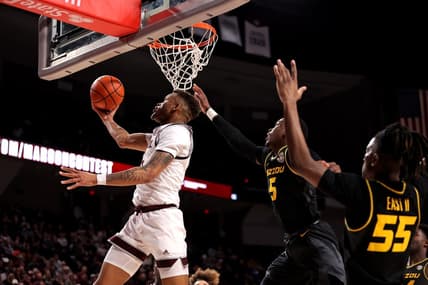 Jan 11, 2023; College Station, Texas, USA; Texas A&M Aggies guard Dexter Dennis (0) makes a reverse layup while Missouri Tigers guard D'Moi Hodge (5) defends during the second half at Reed Arena. Mandatory Credit: Erik Williams-USA TODAY Sports