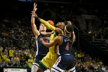 Oregon forward Quincy Guerrier is fouled by Arizona guard Kylan Boswell as the Oregon Ducks host the Arizona Wildcats Saturday, Jan. 14, 2023, at Matthew Knight Arena in Eugene, Ore.

Ncaa Basketball Arizona At Oregon Men S Basketball