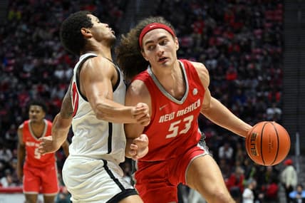 Jan 14, 2023; San Diego, California, USA; New Mexico Lobos forward Josiah Allick (53) dribbles the ball while defended by San Diego State Aztecs guard Matt Bradley (20) during the second half at Viejas Arena. Mandatory Credit: Orlando Ramirez-USA TODAY Sports