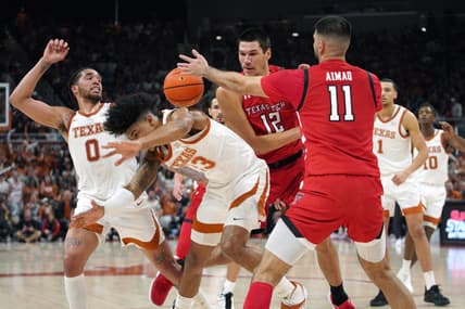 Jan 14, 2023; Austin, Texas, USA;  Texas Longhorns forward Dillon Mitchell (23) forward Timmy Allen (0), Texas Tech Red Raiders forward Fardaws Aimaq (11), and forward Daniel Batcho (12) fight for control of the ball during the first half in a 72-70 Longhorns win at Moody Center. Mandatory Credit: Dustin Safranek-USA TODAY Sports