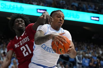 Jan 21, 2023; Chapel Hill, North Carolina, USA; North Carolina Tar Heels forward Armando Bacot (5) grabs a rebound as North Carolina State Wolfpack forward Ebenezer Dowuona (21) defends in the first half at Dean E. Smith Center. Mandatory Credit: Bob Donnan-USA TODAY Sports