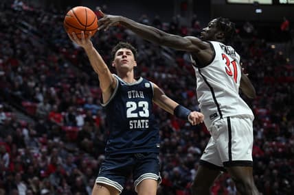 Jan 25, 2023; San Diego, California, USA; Utah State Aggies forward Taylor Funk (23) shoots the ball past San Diego State Aztecs forward Nathan Mensah (31) during the second half at Viejas Arena. Mandatory Credit: Orlando Ramirez-USA TODAY Sports